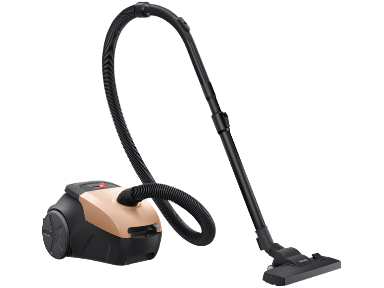 Kompakt koppar- och svart dammsugare med slang och munstycke.