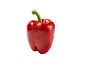 Levande röd paprika med grön stjälk mot svart bakgrund.