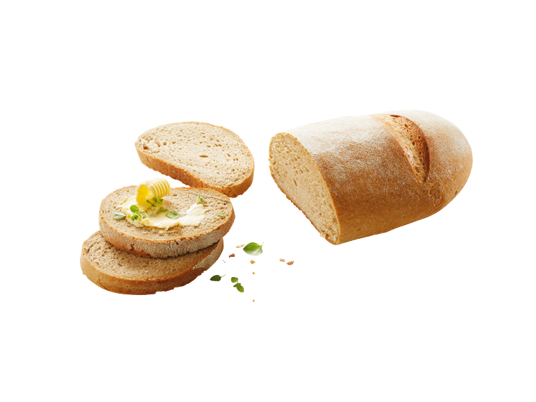 Skivat bröd med smör och örter, bredvid ett bröd.
