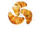 Tre pistagecroissanter, en delad, på svart bakgrund.