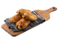 Fyra gyllenbruna pain au chocolat på en rutig kökshandduk på en träskärbräda.