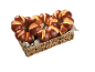 Flätad korg med bruna bullar arrangerade i hjärtform på en grå duk.