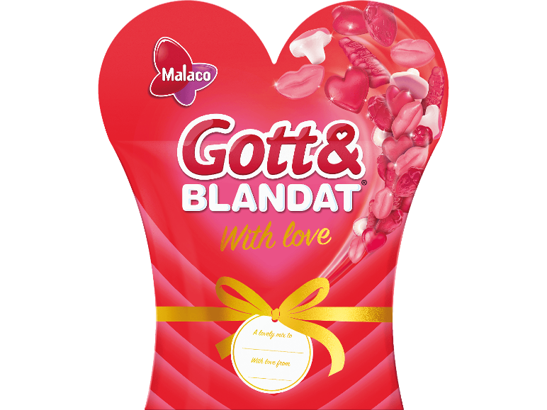 Hjärtformad gelégodispåse med en guldrosett och ett presentkort.