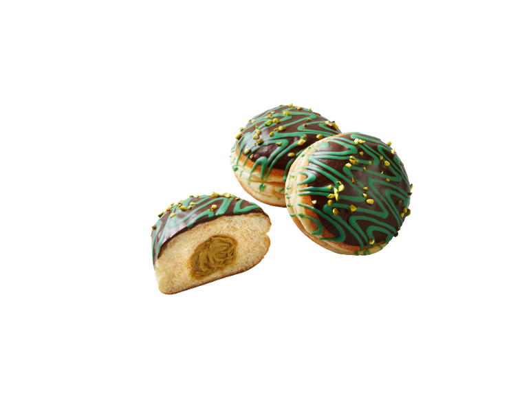 Fyllda munkar med chokladglasyr, grön dekoration och hackade pistagenötter.
