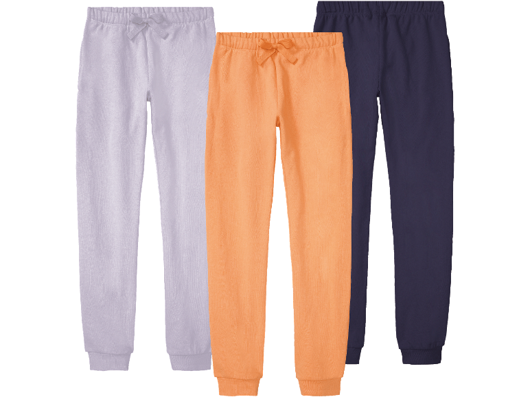 Tre träningsbyxor i olika färger: ljuslila, orange och mörkblå.