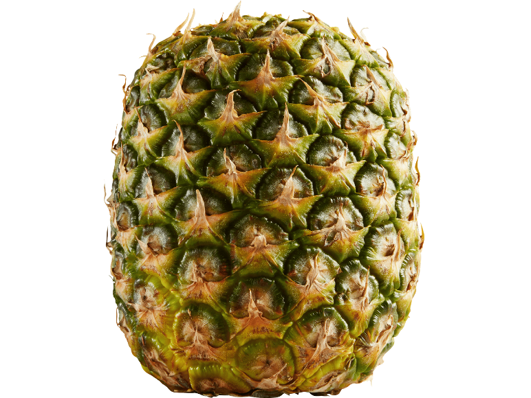 En ananas på svart bakgrund, som visar dess gröna och gula skal.
