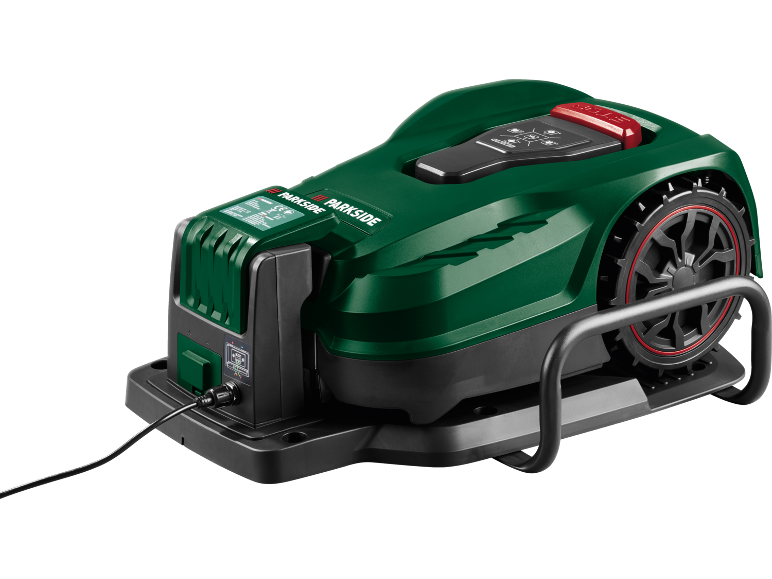 Grön robotgräsklippare med svarta hjul och röda detaljer, laddas på en svart bas.