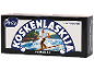 Svart låda med en illustration av en man på en forsande flod, med texten 'LAKTOOSITON VOIMAKAS'.