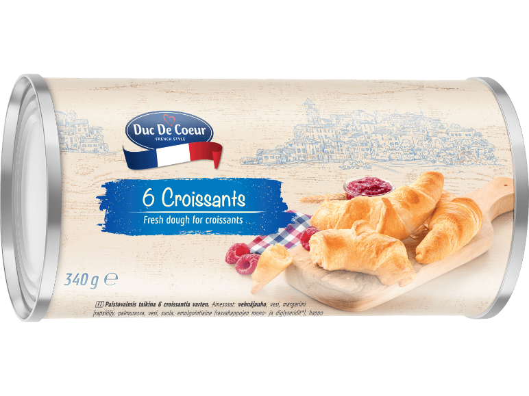 Förpackning med sex croissanter och färsk deg, med franskt tema.