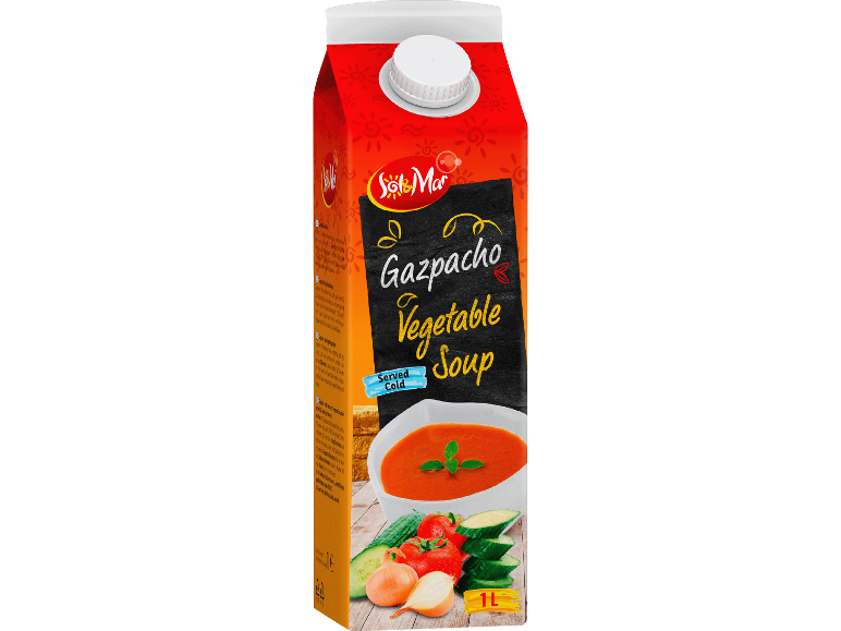 Kartong med gazpacho grönsakssoppa, med en skål soppa och färska grönsaker.