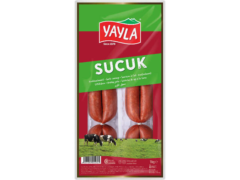 Förpackning vitlökskorv sucuk med kor på ett fält.