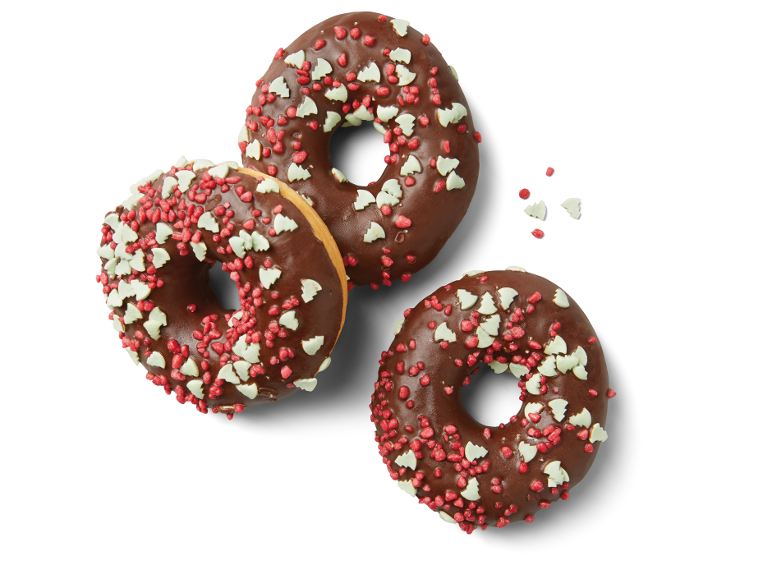 Tre chokladdunkar med röda och vita juldekorationer.