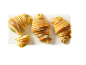 Fyra gyllene croissanter fyllda med pistage och dekorerade med ljusgrön glasyr på en vit bräda.