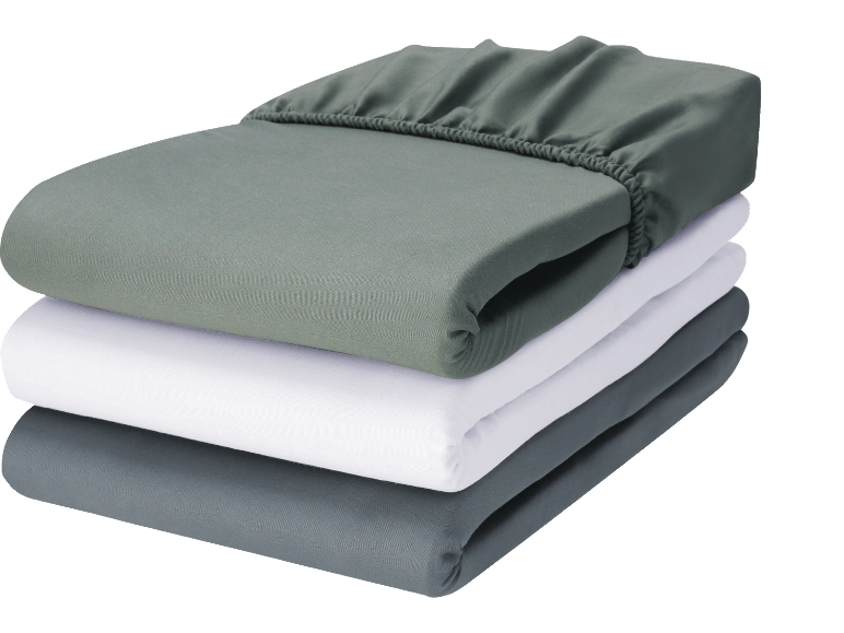 Set med ekologiska bomullslakan i grönt, vitt och grått.