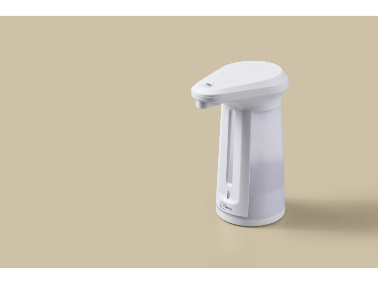 Vit automatisk tvåldispenser med transparent behållare på beige bakgrund.